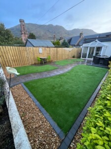 "Immerse yourself in the beauty of nature with this stunning garden in Tillicoultry. The picturesque view of the Ochil Hills combined with the lush artificial grass and inviting pathway creates a tranquil oasis that's perfect for relaxation and enjoyment. Get inspired by the seamless blend of nature and modern design in this breathtaking garden." A breathtaking garden in Tillicoultry overlooking the majestic Ochil Hills. The garden features a lush green artificial grass lawn and a beautifully paved path.