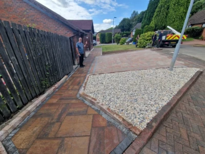 Transform your outdoor space with a stunning Tobermore driveway installation in Tullibody, Alloa. The Shannon Heather pavers, complemented by a stylish Graphite border and a charming Historic Heather path, create a beautiful and inviting entrance to your home. Enhance your curb appeal and make a lasting impression with this elegant driveway design. Alt Text: A stunning Tobermore driveway installation in Tullibody, Alloa. The customer opted for a captivating combination of Tobermore Shannon Heather pavers for the main driveway, complemented by a stylish graphite border. Additionally, a charming Historic Heather path completes the design, creating a visually appealing and inviting entrance to the property.