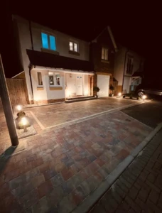 "Experience the allure of a Tobermore driveway installation in Kirkliston, Edinburgh, as it comes alive in the enchanting glow of nighttime lights. The impeccable craftsmanship and timeless elegance of Tobermore pavers are beautifully showcased in this captivating scene. Let the warm ambiance and sophisticated design of this illuminated driveway welcome you home with style and grace." house for sale in edinburgh
