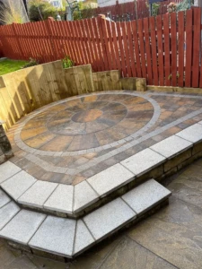 "Captivating Tobermore Historic circle installation in Currie, Edinburgh, adding charm and character to the outdoor space with its timeless design and warm-toned bricks." A stunning Tobermore Historic circle installation in Currie, Edinburgh. The circular paving pattern features a beautiful blend of warm-toned bricks, creating an inviting and timeless look for the outdoor space."